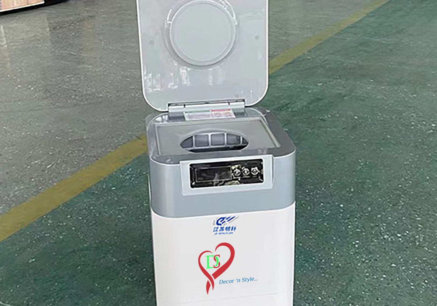 A small white and gray machine sitting on the floor.